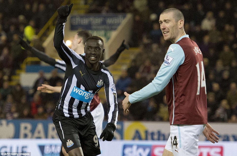 Cisse (left) races away to celebrate his 48th minute equaliser as Burnley's David Jones looks on 