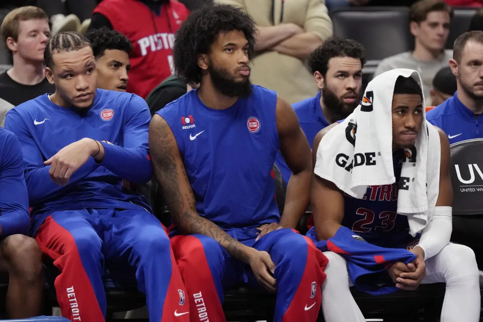 From left, Detroit Pistons forward Kevin Knox II, forward Marvin Bagley III, and guard Jaden Ivey sit on the bench during the closing minutes of the second half of an NBA basketball game against the Memphis Grizzlies, Wednesday, Dec. 6, 2023, in Detroit. (AP Photo/Carlos Osorio)