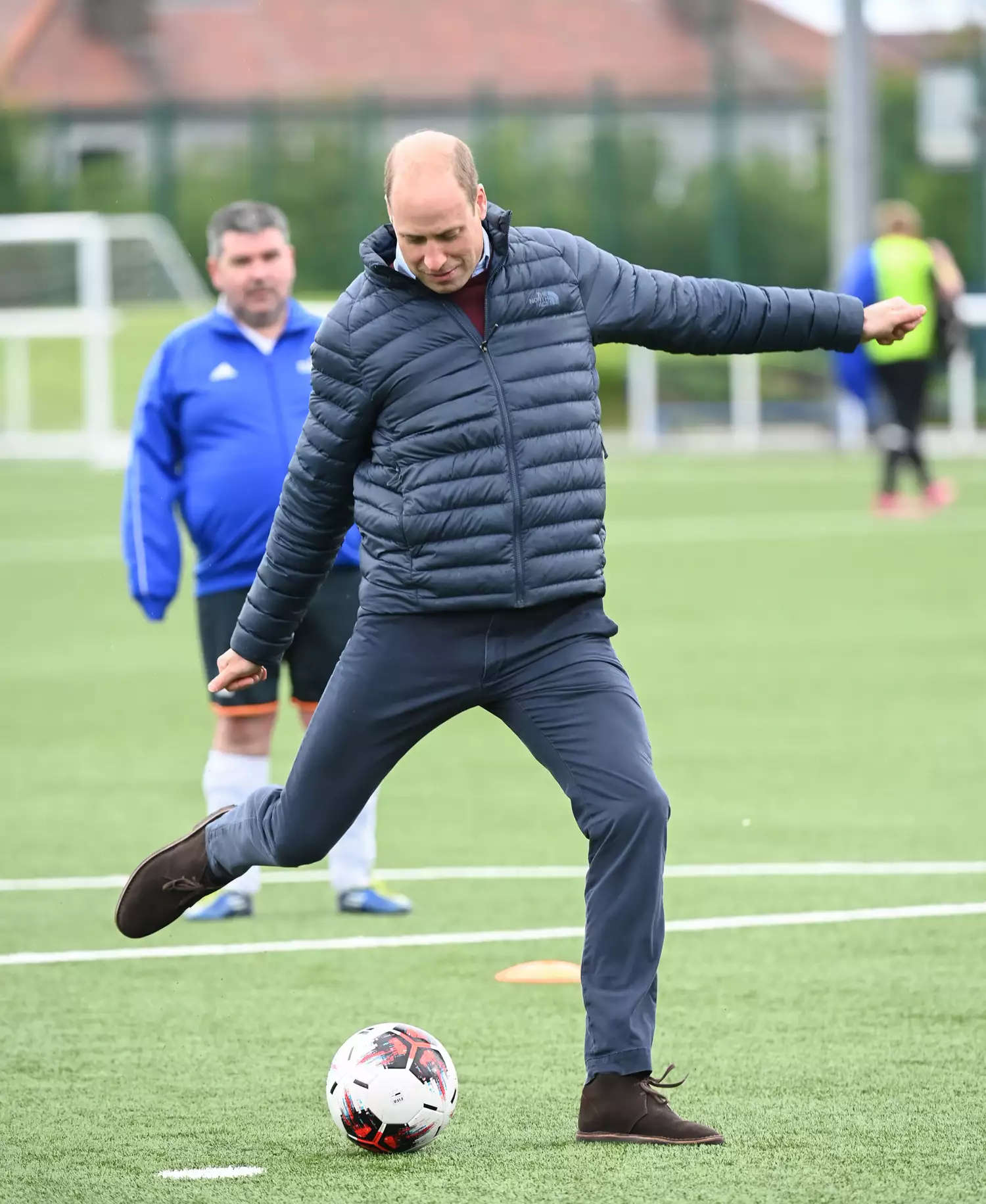 Prince William, Duke of Cambridge plays football during a visit to Spartans FC's Ainslie Park Stadium