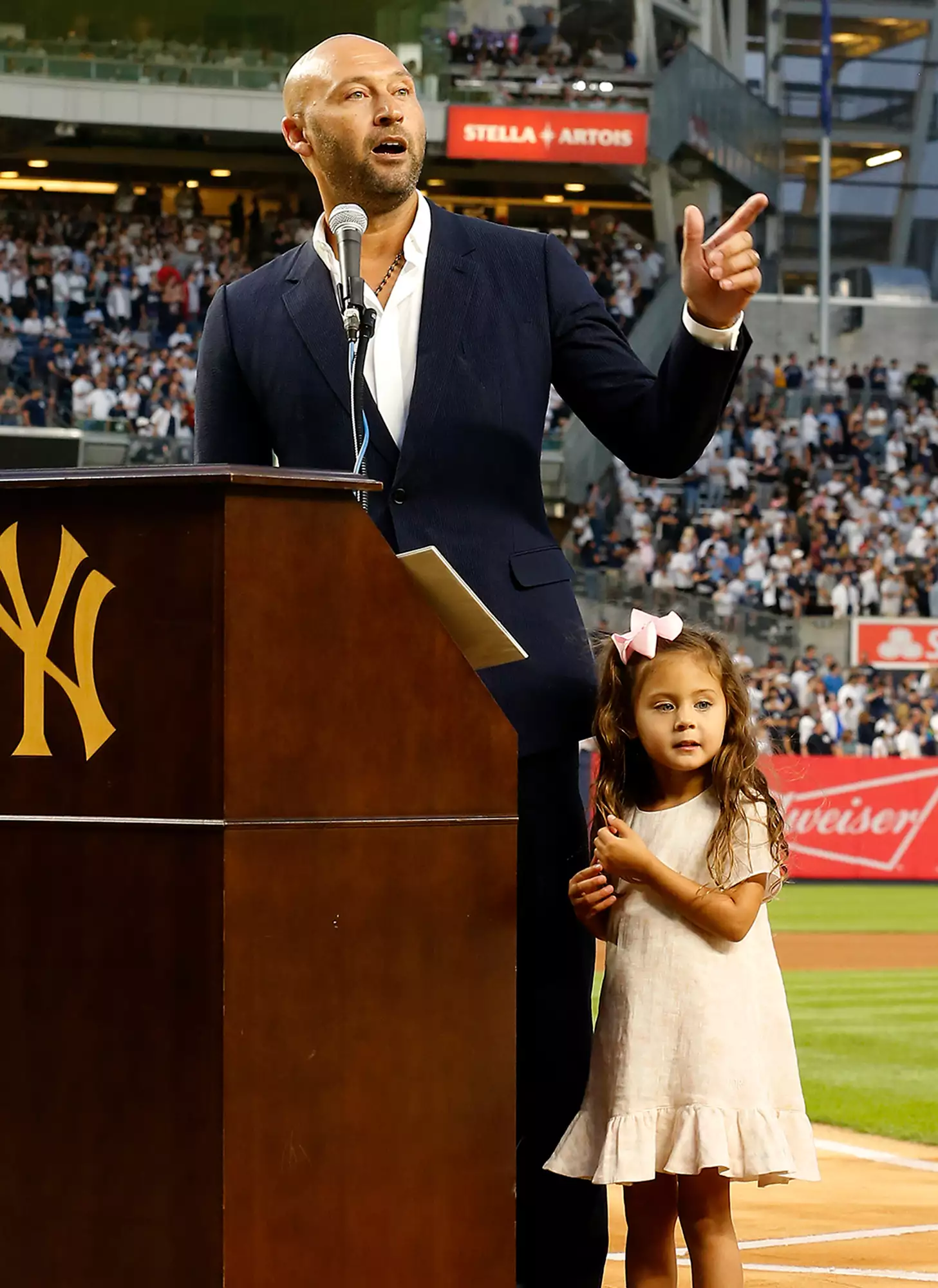 Derek Jeter speaks to the fans alongside his daughter Story as he is honored by the New York Yankees before a game against the Tampa Bay Rays at Yankee Stadium on September 09, 2022 in the Bronx borough of New York City