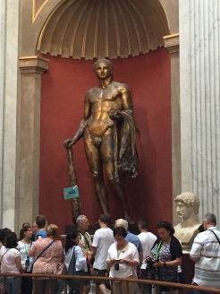 This gilded bronze statue was found in 1864 beneath the courtyard of the Palazzo Pio Righetti, near Campo de' Fiori, and in the area of Pompey's Theatre. Shortly afterwards it was given to Pope Pius IX (1846-1878). At the moment of discovery the statue was lying horizontally in a trench and covered by a slab of travertine on which the letters F C S (Fulgur Conditum Summanium) had been cut. The statue had, therefore, been struck by lightning and, following the Roman custom, had been granted a ritual burial together with the remains of a lamb. The statue was restored by Pietro Tenerani who made repairs using plaster and bronze. It shows a young Heracles leaning on his club, with the skin of the Nemean lion over his arm, and the apples of the Hesperides in his left hand. The work was, perhaps, inspired by a model from the Attic School of between 390 and 370 B.C. and has been variously dated to between the end of the 1st and the beginning of the 3rd century A.D.