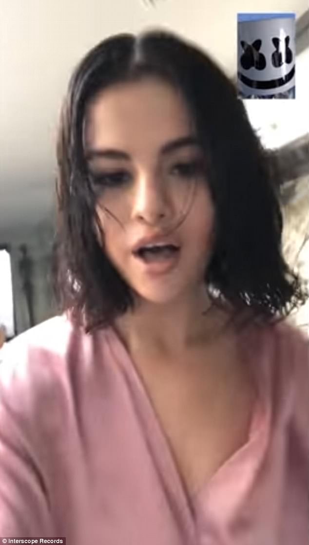 Sultry: Selena Gomez wore nothing but a silk pink robe for her new music video with EDM producer Marshmello titled Wolves released on Thursday