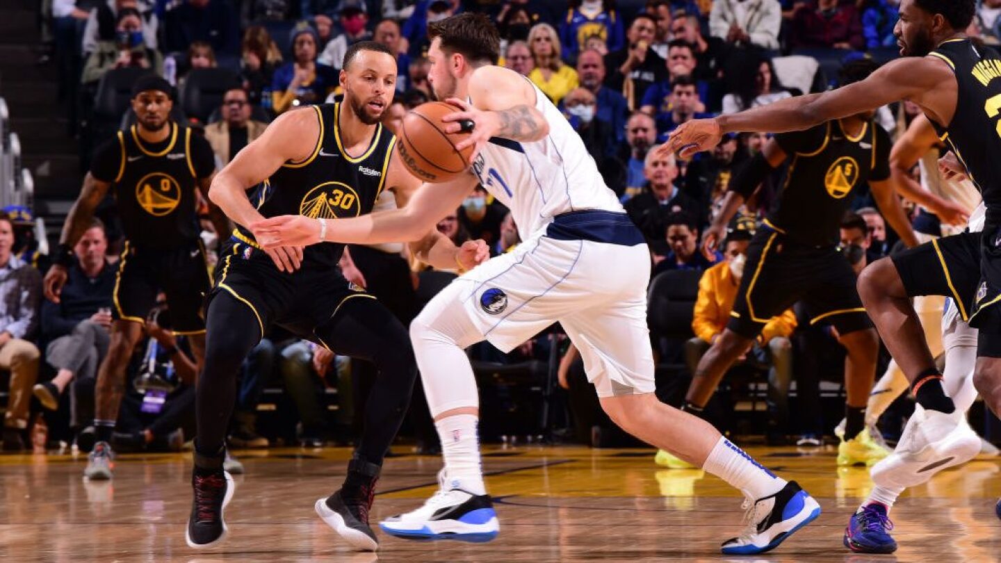 Stephen Curry plays defense on Luka Doncic in Dallas Mavericks v Golden State Warriors