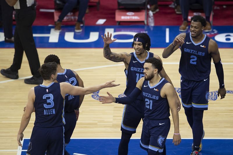 Grayson Allen #3, Brandon Clarke #15, Tyus Jones #21 and Xavier Tillman #2 of the Memphis Grizzlies celebrate