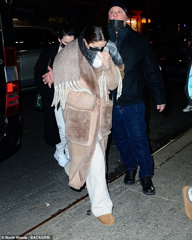 Warm and comfortable: The singer, 29, bundled up in warm clothes for the occasion, sporting an oversized tan coat lined with fur and a pair of grey sweatpants