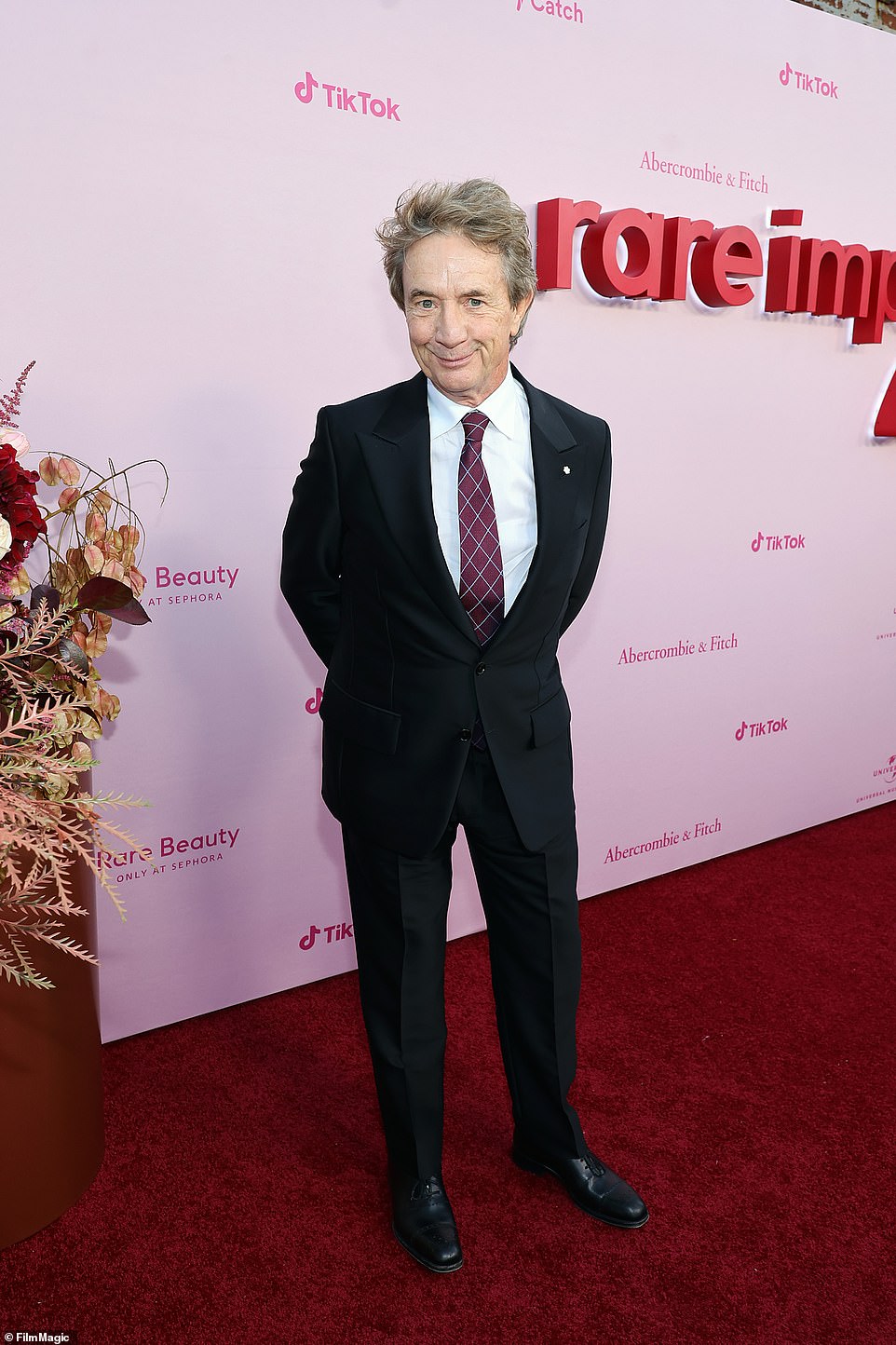 Sweet: Selena's Only Murders in the Building co-star Martin Short,  73, looked sharp in a black suit with a red and white tie