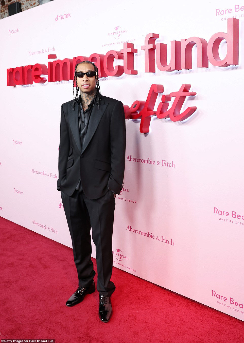 Handsome: Kylie Jenner's ex-boyfriend Tyga, 33, looked handsome in a black suit and matching silk black shirt