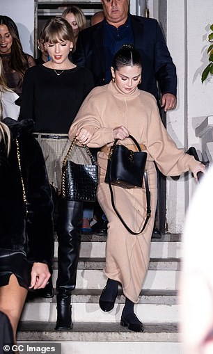 Effortlessly stylish: She threw up her raven black tresses into a sleek and chic bun to showcase a pair of chunky, gold hoop earrings