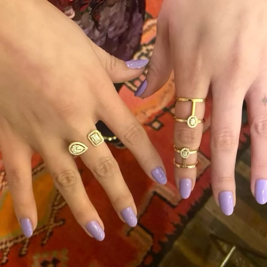 Up close shot of Selena Gomez's pastel purple manicure and gold rings