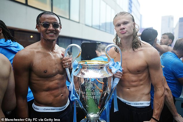 Manuel Akanji (left) also flaunted his shredded figure as Manchester City celebrated the Treble