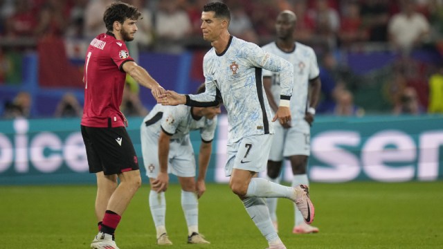 Portugal's Cristiano Ronaldo shakes hand with Georgia's Khvicha Kvaratskhelia